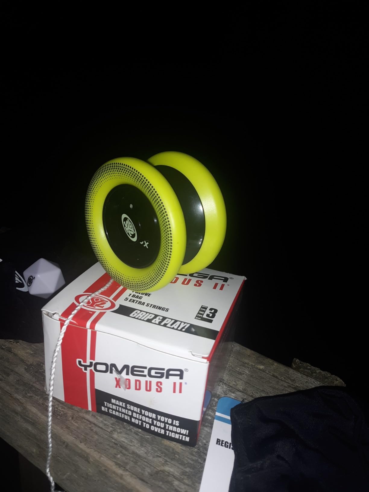 Yomega Xodus II yo-yo with yellow rims sitting on its box